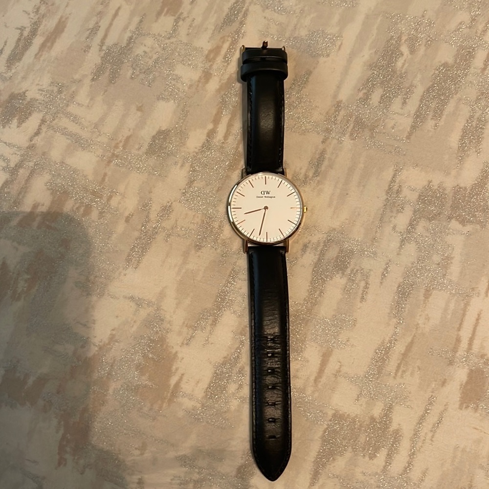 Daniel Wellington watch with black leather strip gold face